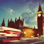 Red bus, Big Ben and Westminster Palace in London, the UK. at night. Moon shining. Vintage